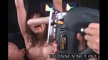 A chick gets her pussy with a drill bit in the form of a rubber dick in a torture chamber